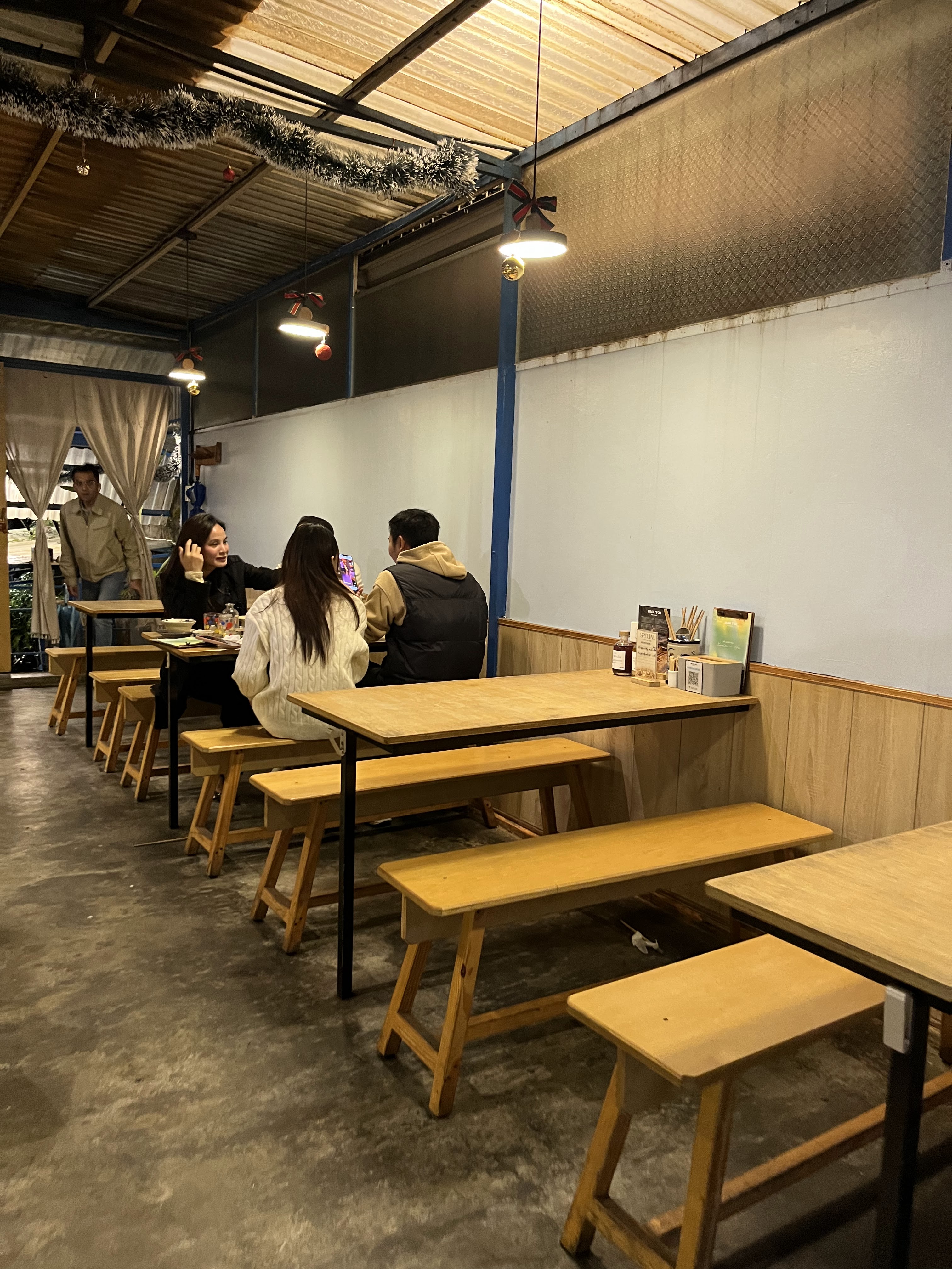 Mâm cơm tối tại BỮA TỐI Đà Lạt — thịt nướng than, rau và cơm trắng dọn trên bàn gỗ.
